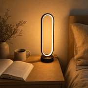 Halo Ring Lamp on a bedside nightstand in warm light