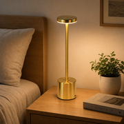 Gold Lumi cordless lamp on a bedside nightstand