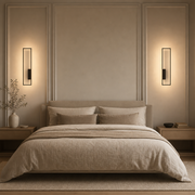 Pair of black Arc wall lamps framing a bed