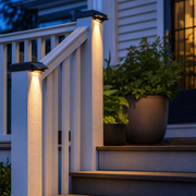 Solar lights on a front porch railing at dusk
